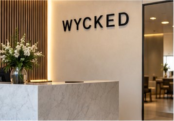 WYCKED in black block letters above a marble salon reception desk
